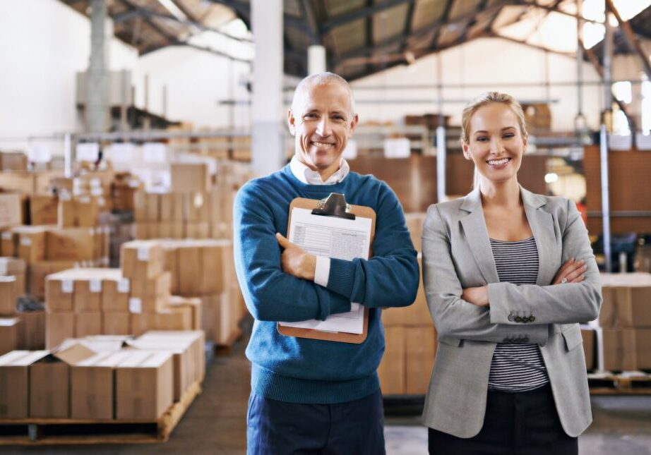 Portrait of two managers standing in a distribution warehouse